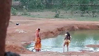 Desi woman washes her ass outdoors
